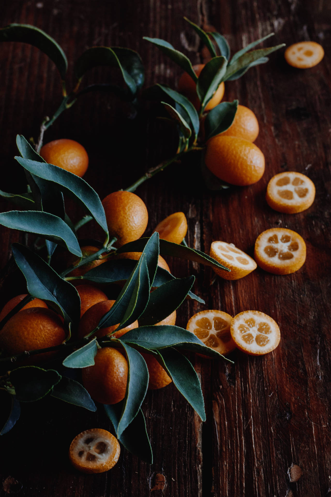 Kumquat Fruits With Leaves On Wood