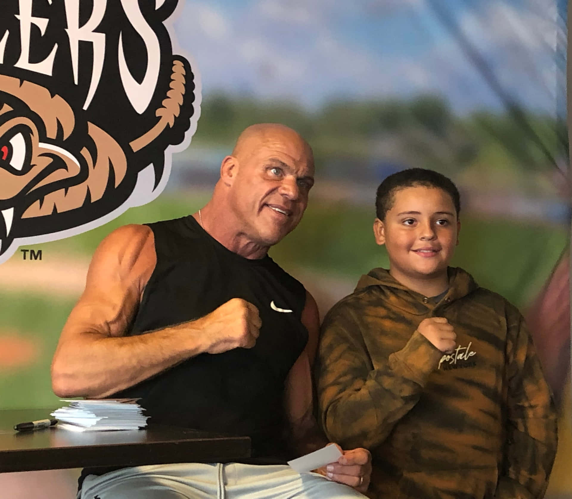 Kurt Angle Enjoying A Cheerful Moment With A Fan Background
