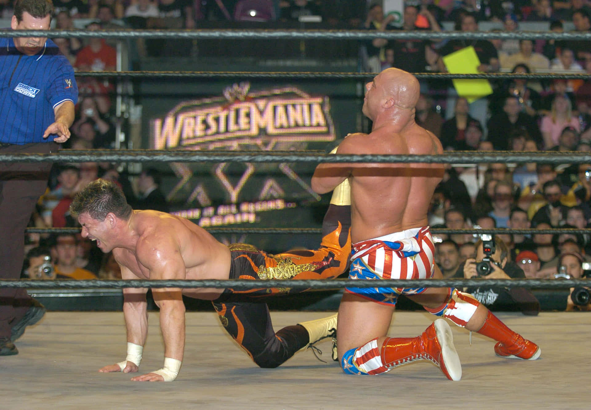 Kurt Angle Holding Eddie Guerrero In A Leg Lock Background