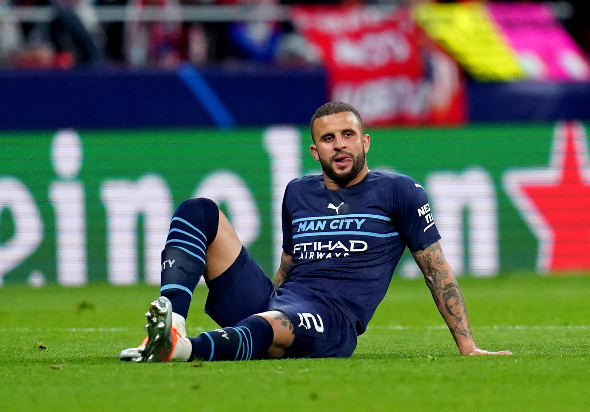 Kyle Walker Sitting On The Field Background