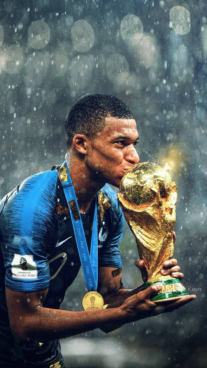 Kylian Mbappe Kissing World Cup Trophy Background