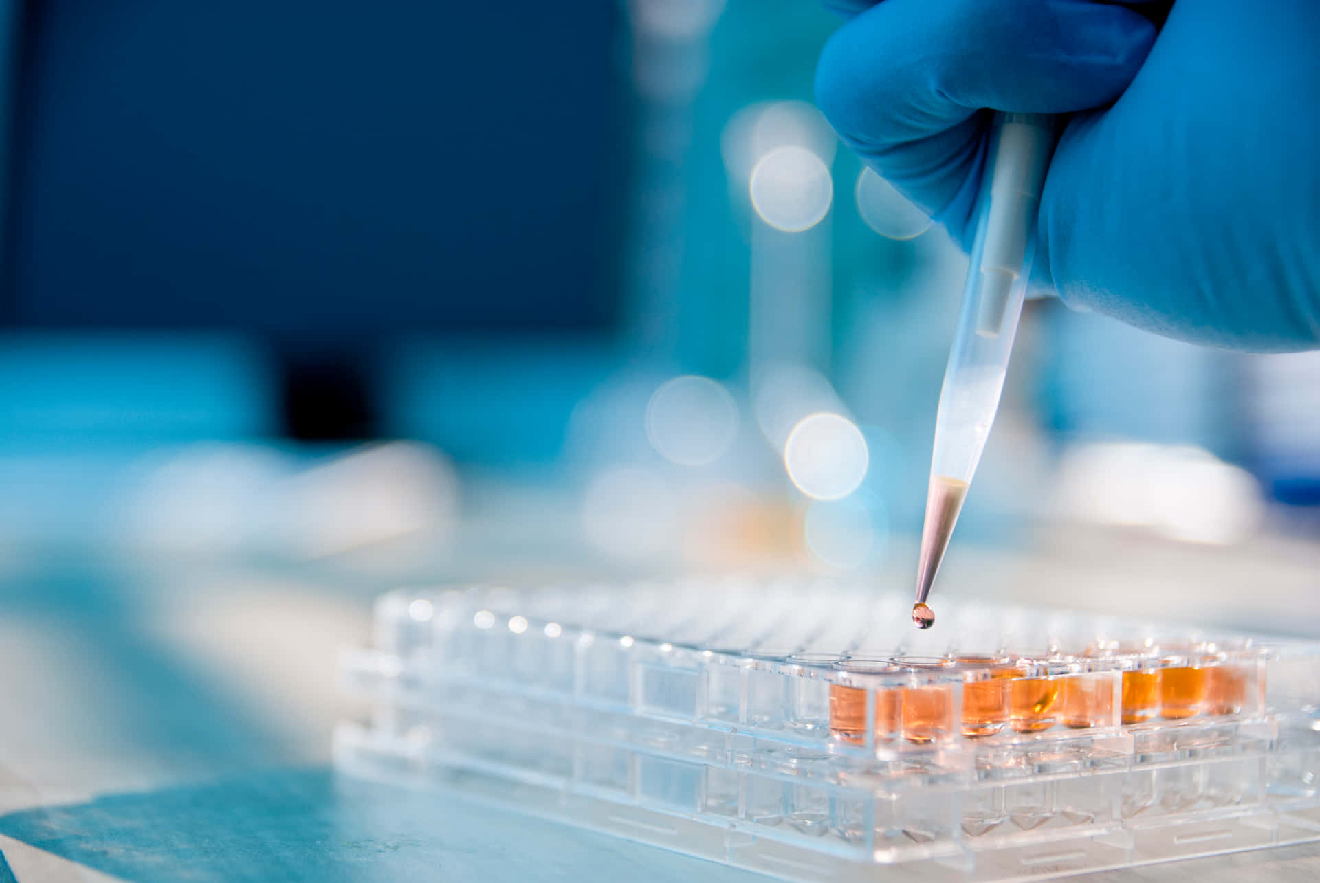 Laboratory Pipette Pouring Orange Liquid Background