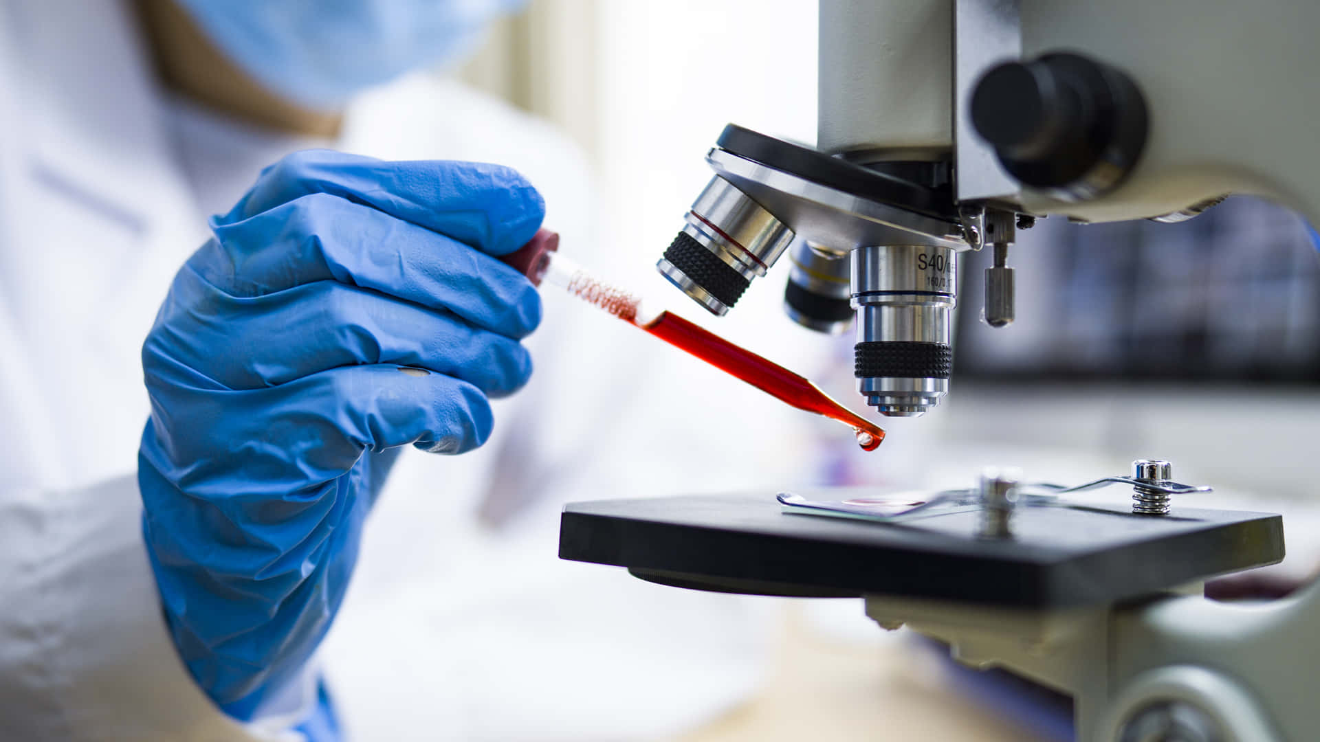 Laboratory Red Liquid Onto Microscope