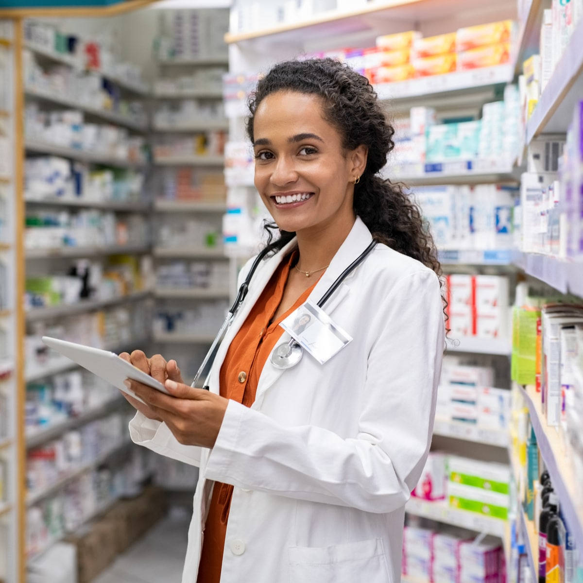 Lady Pharmacist Smiling Holding An Ipad Background
