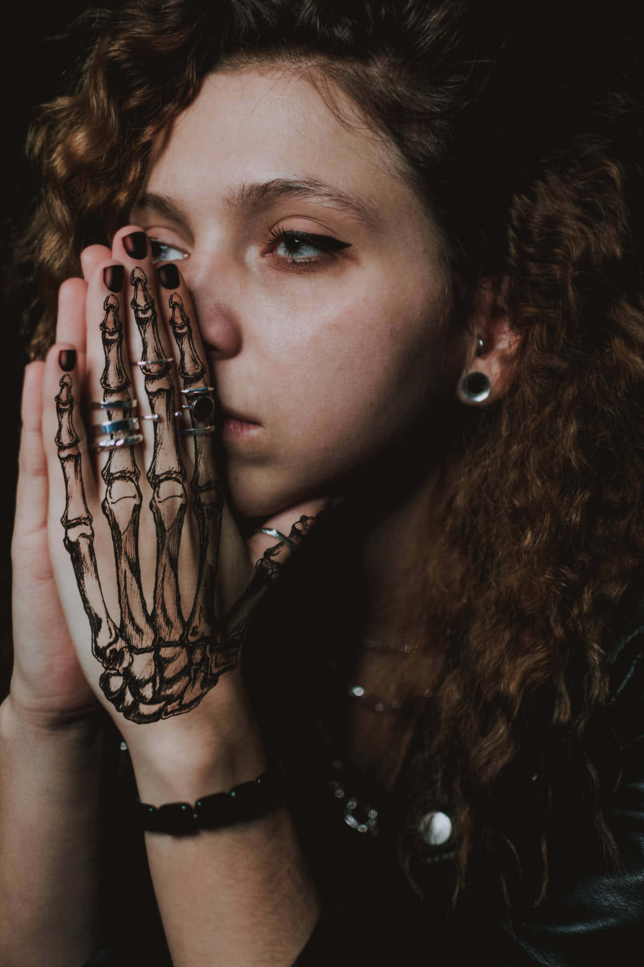 Lady With Skeletal Hand Tattoo Background