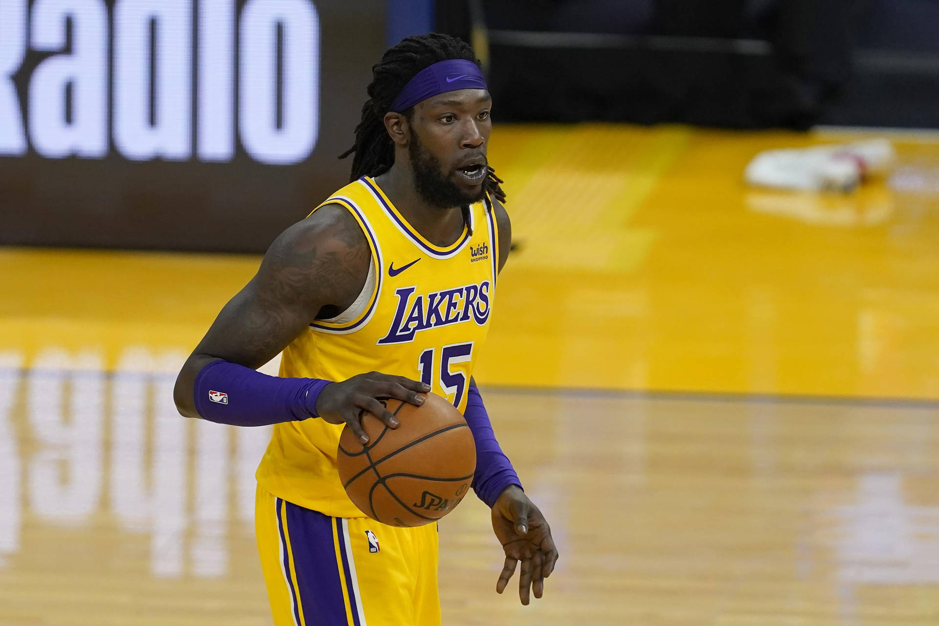 Lakers Montrezl Harrell Dribbles On Court Background