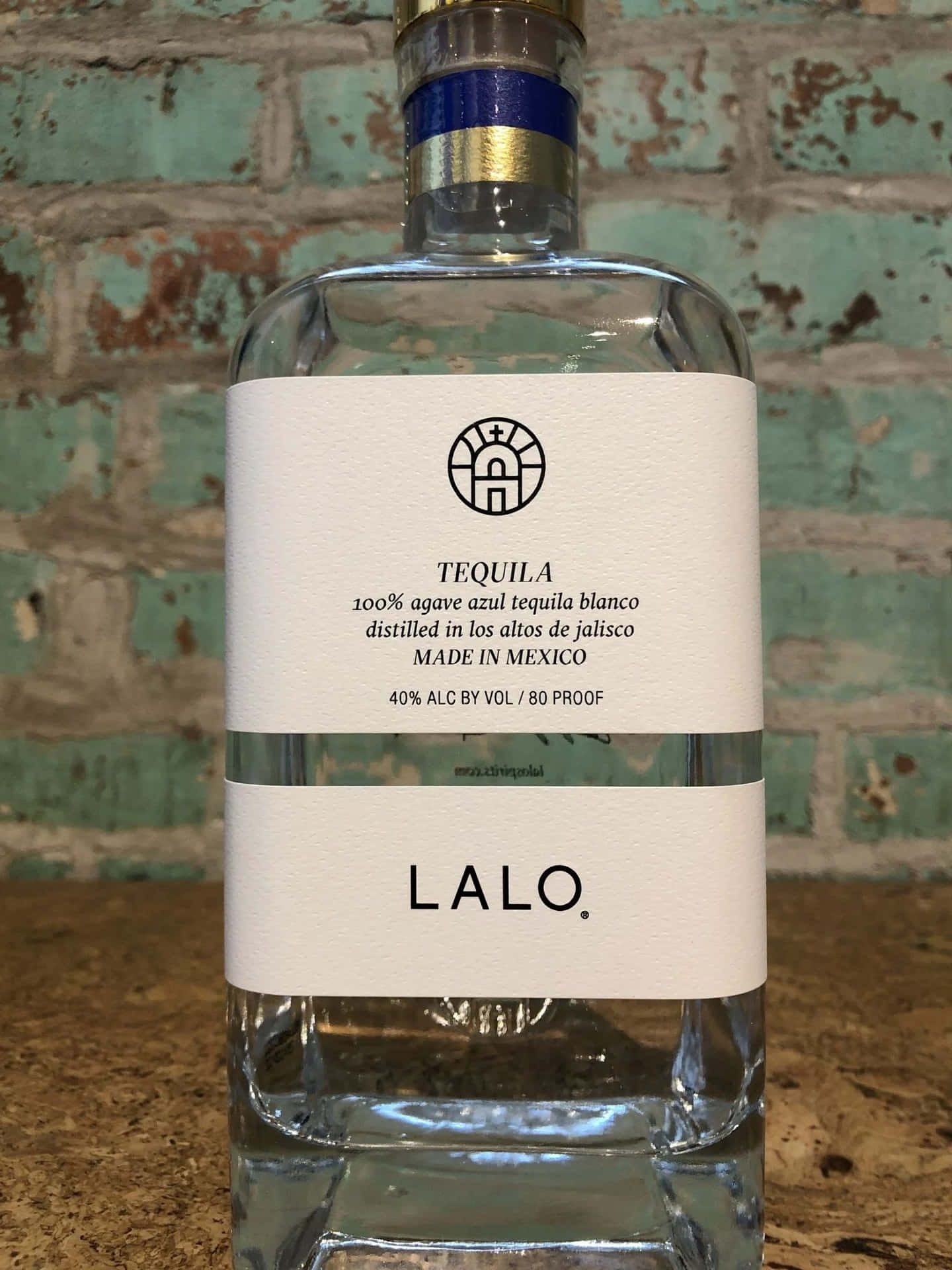 Lalo Tequila Bottle Against Brick Background Background