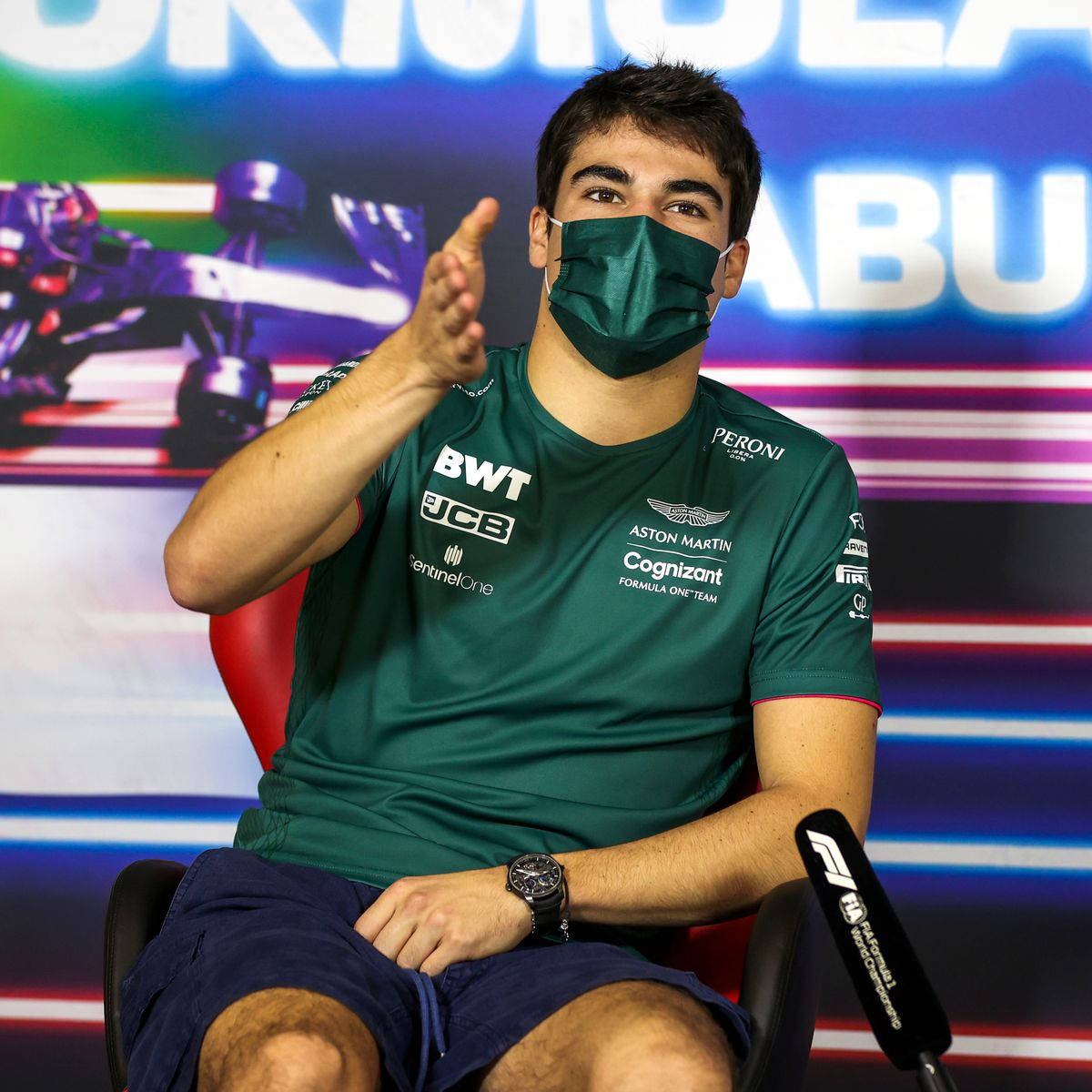 Lance Stroll Speaking At A Press Conference In Abu Dhabi Background