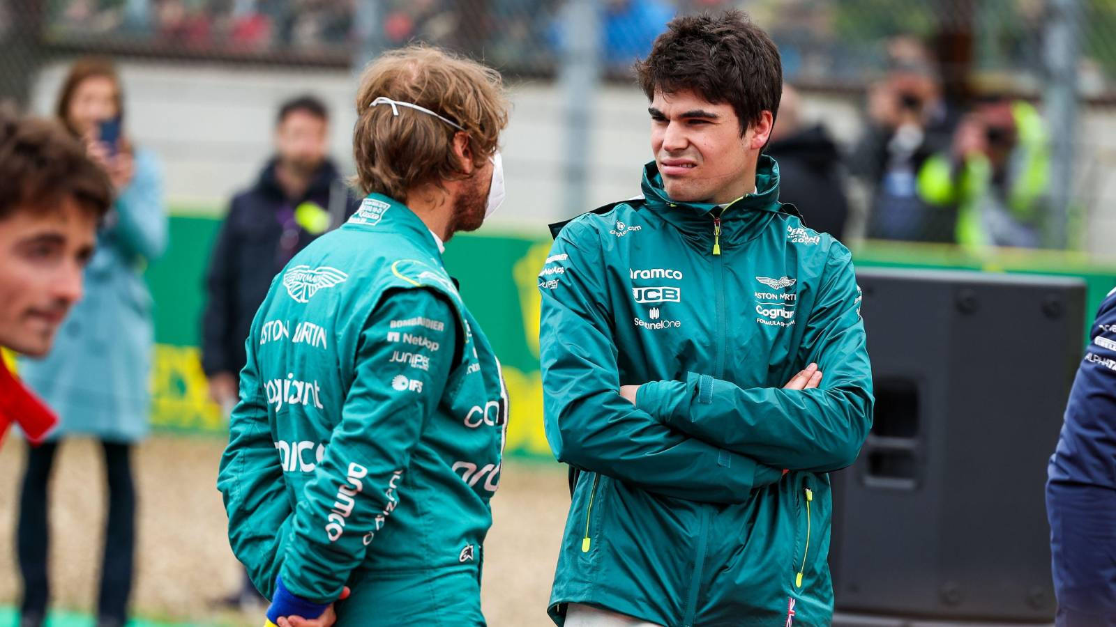 Lance Stroll Talking To Teammate Background