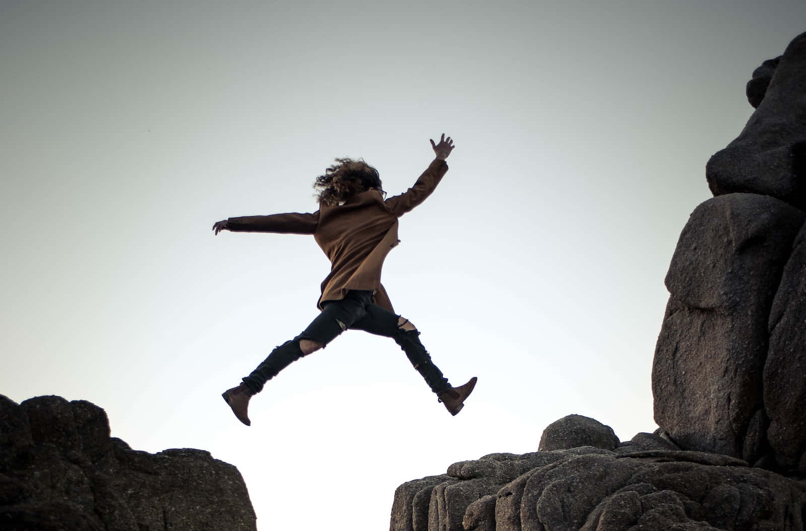 Languishing Woman On The Cliff Background