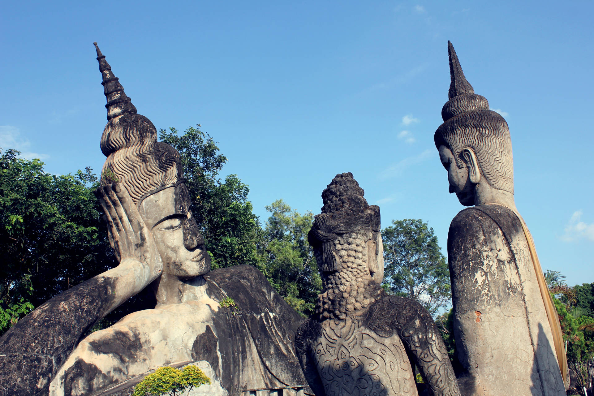 Laos Leaning Statues At Park Background