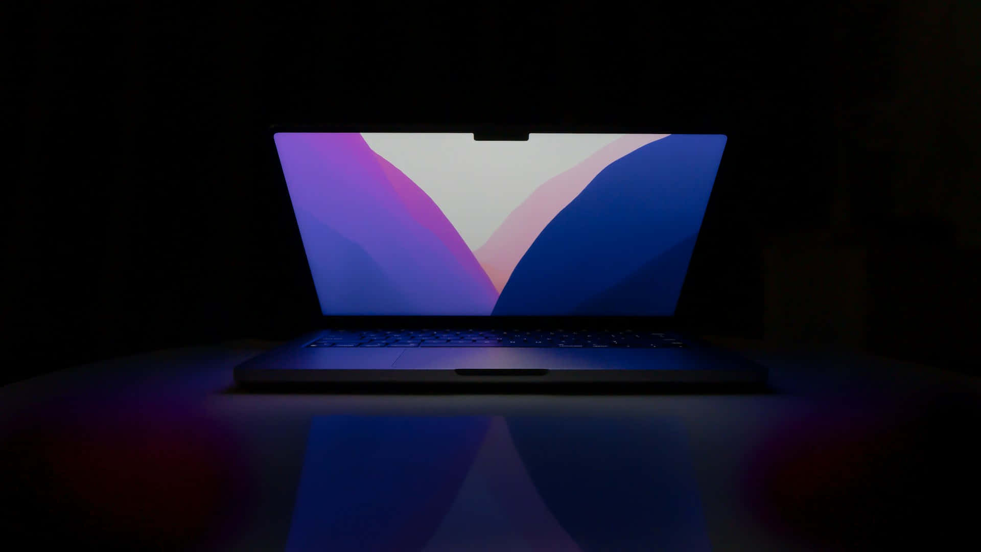 Laptop Illuminatedin Darkness Background