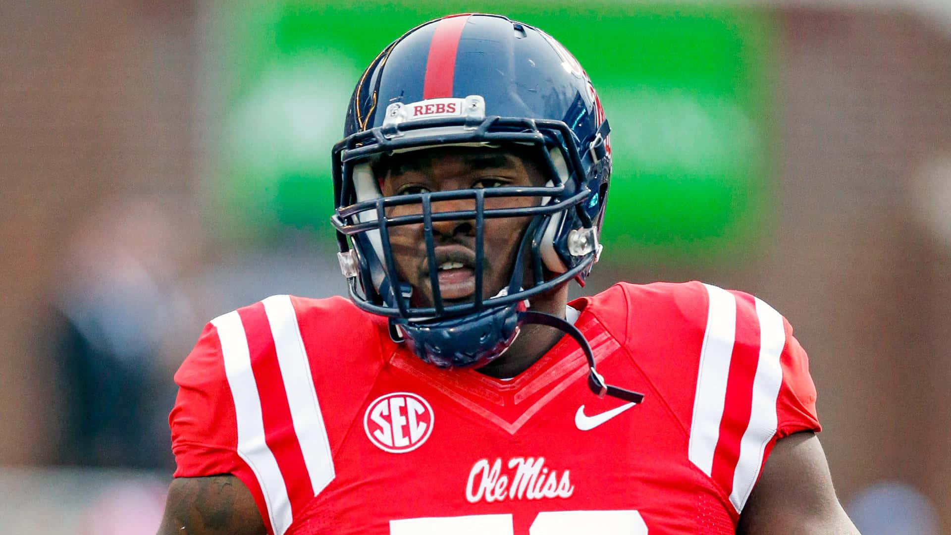 Laremy Tunsil Black Helmet Red Football Jersey Background