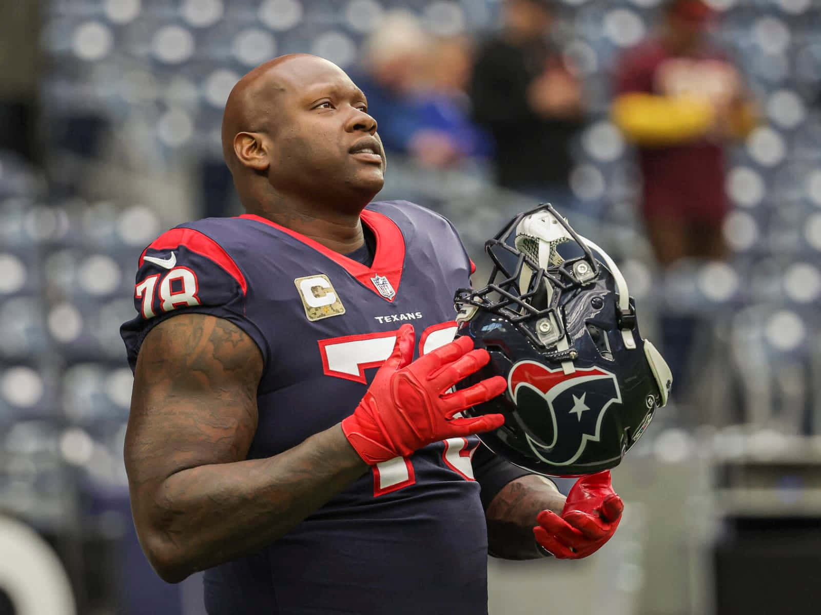 Laremy Tunsil Holding His Black Football Helmet Background
