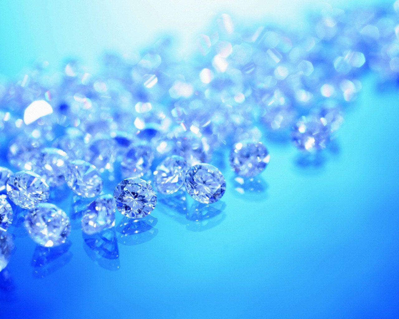 Larger-than-life Blue Diamond Crystals Sparkle Brilliantly Against A White Background.