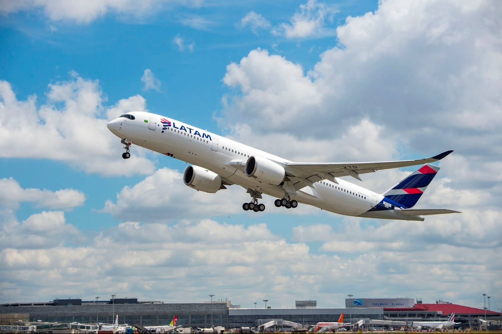 Latam Airlines Plane Ascending Over Cloudy Sky Background