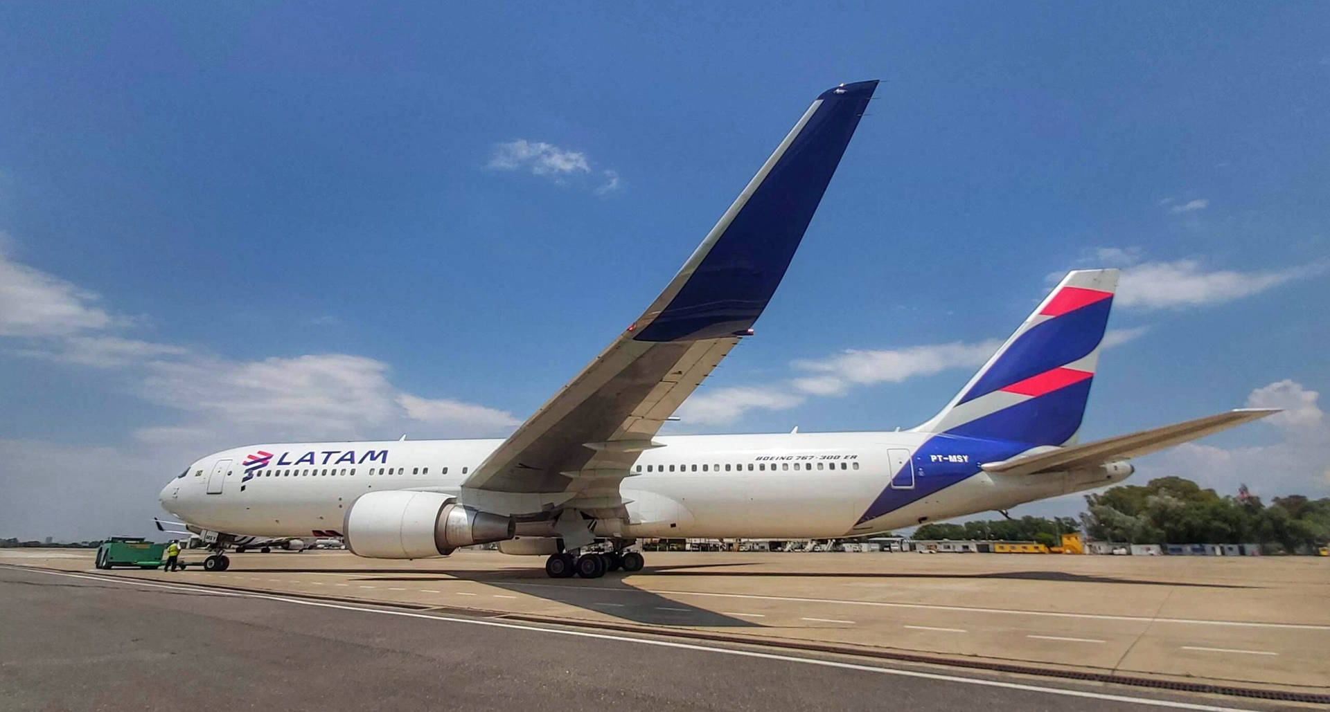 Latam Airlines Plane Parked In The Airport Background