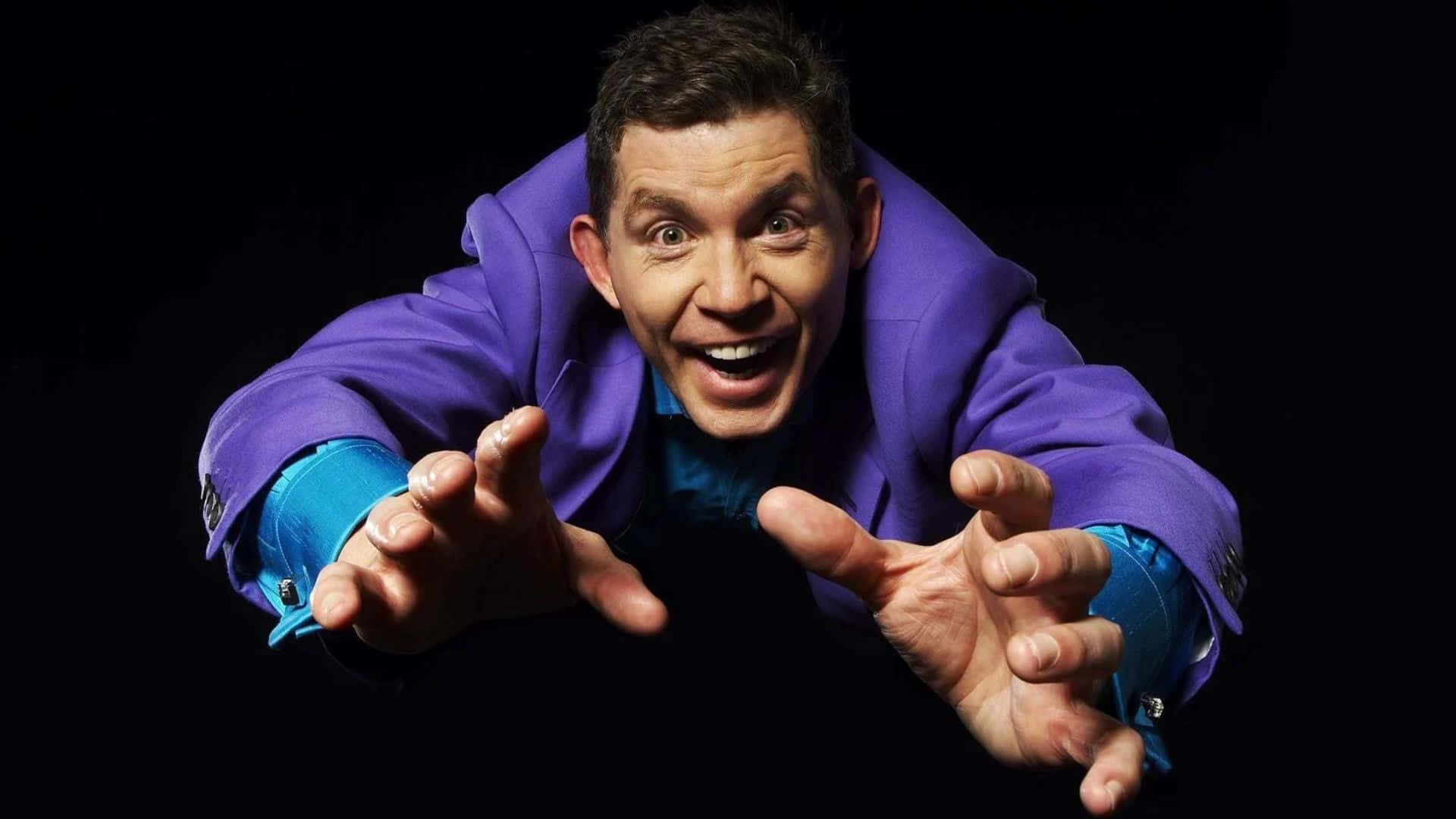 Lee Evans Performing On Stage Background