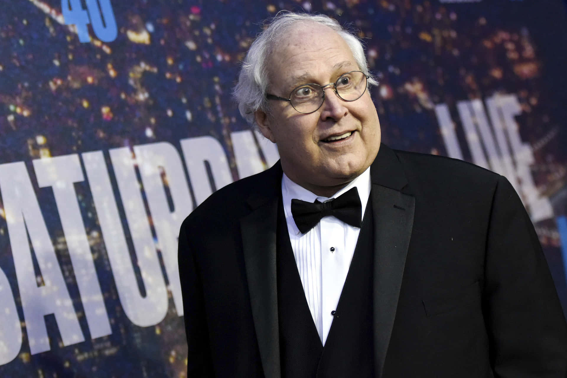Legendary Actor Chevy Chase In Pensive Pose Background