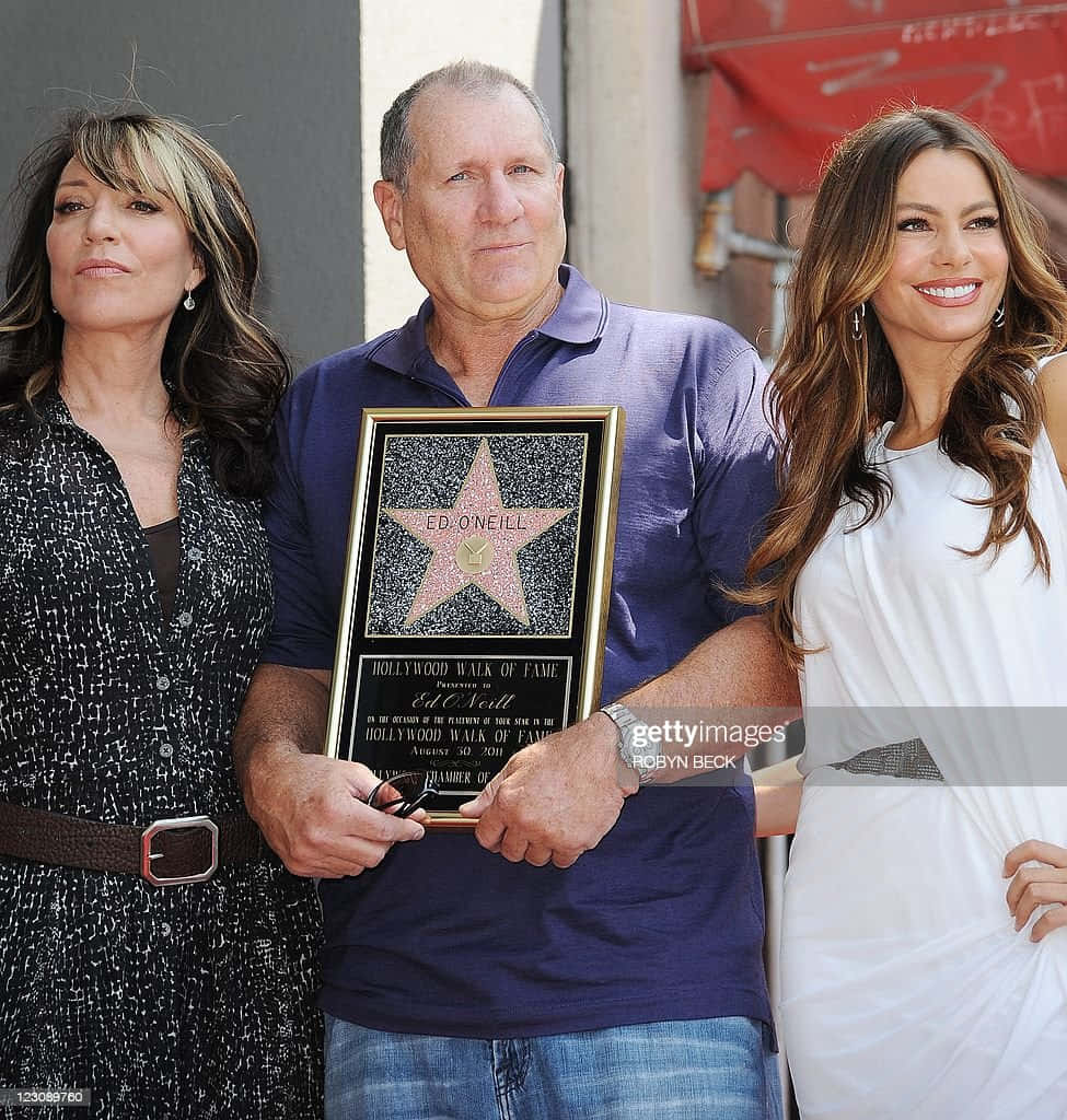 Legendary Actor Ed O'neill In A Reflective Moment Background