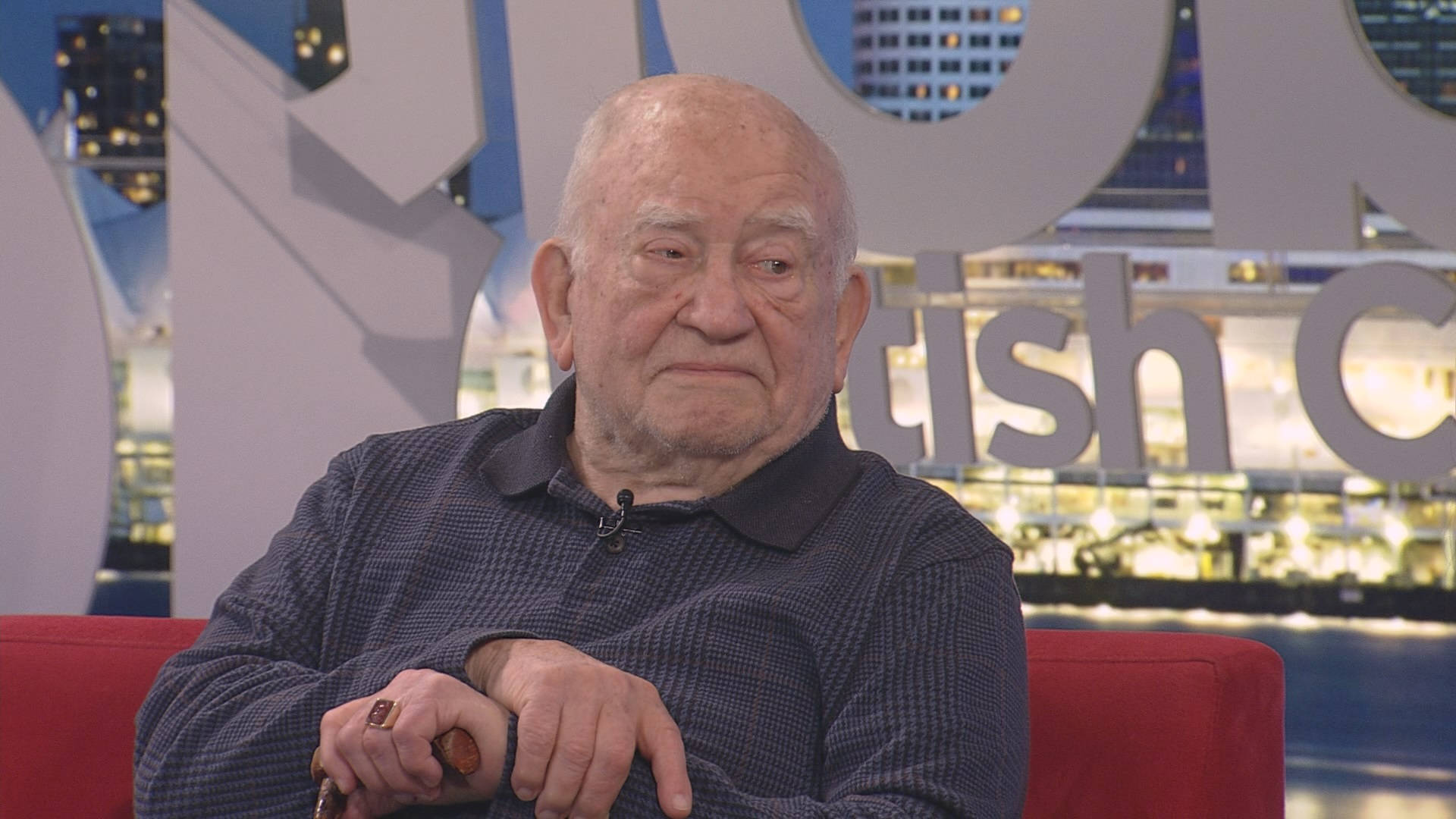 Legendary Actor Edward Asner Relaxing On A Red Couch