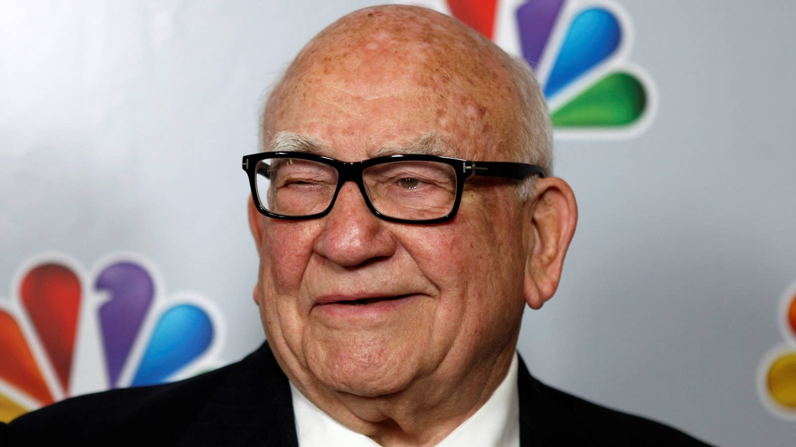 Legendary Actor Edward Asner With Nbc Logo Background