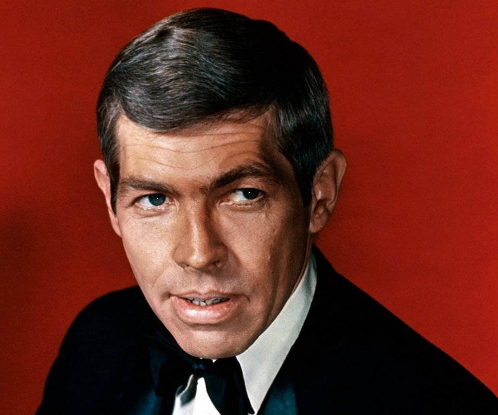 Legendary Actor James Coburn In A Still From 'in Like Flint' Background