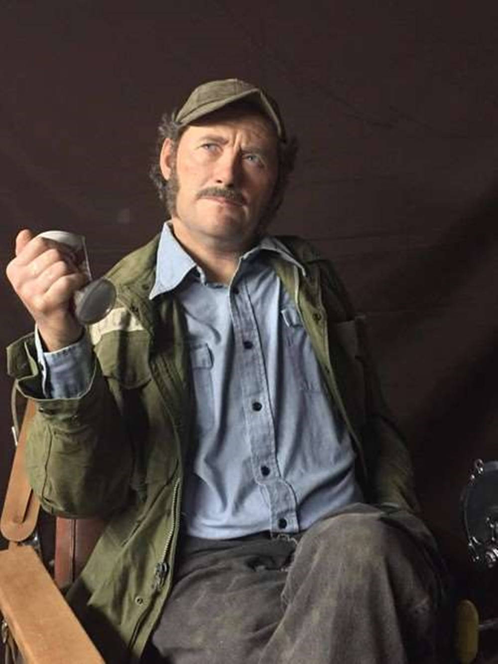 Legendary Actor Robert Shaw Glancing In A Dark Setting Background