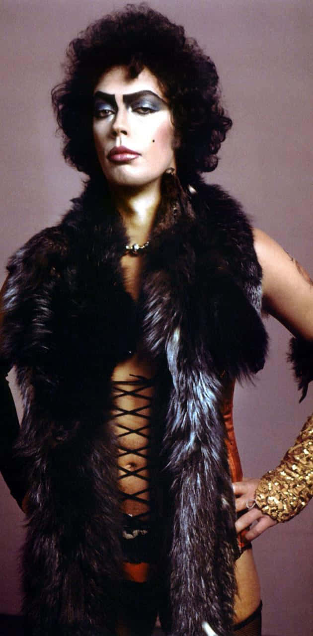 Legendary Actor Tim Curry Posing In A Striking Portrait Background