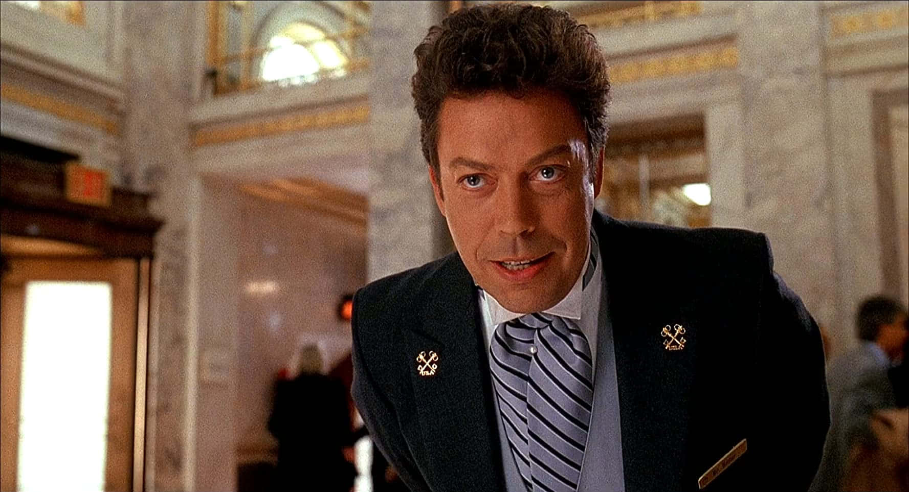 Legendary Actor Tim Curry Smiling In An Iconic Pose Background