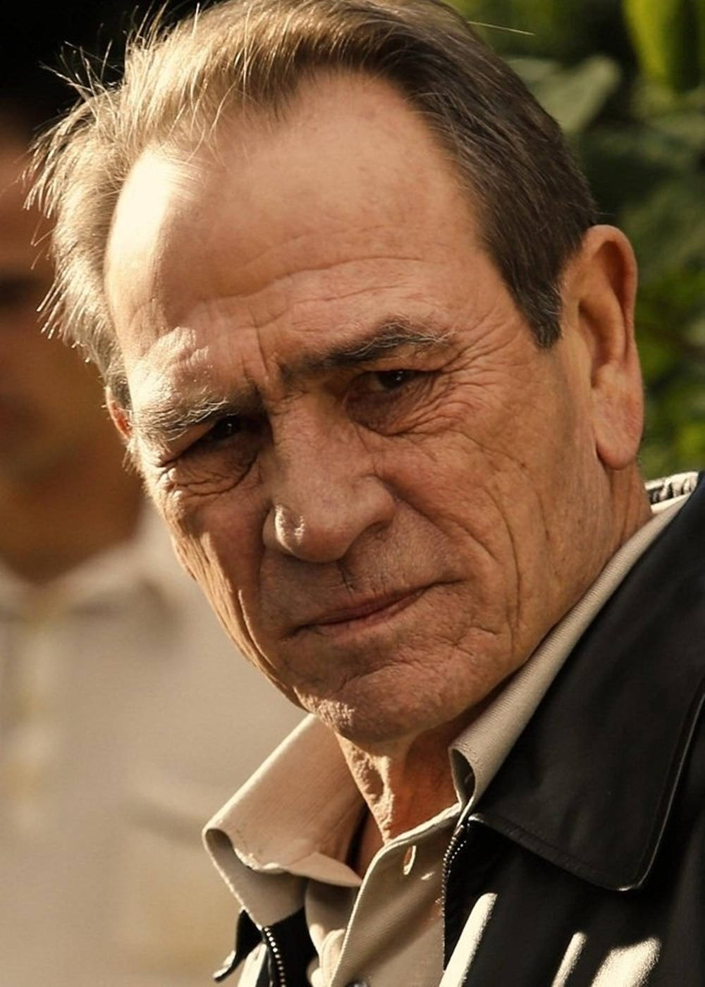 Legendary Actor Tommy Lee Jones With A Dazzling Smile Background