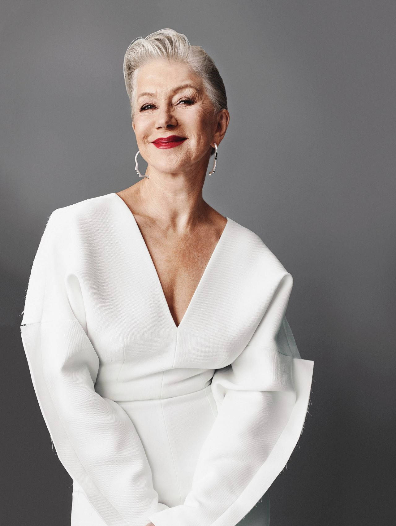 Legendary Actress Helen Mirren Posing Elegantly In A Professional Studio Photoshoot Background