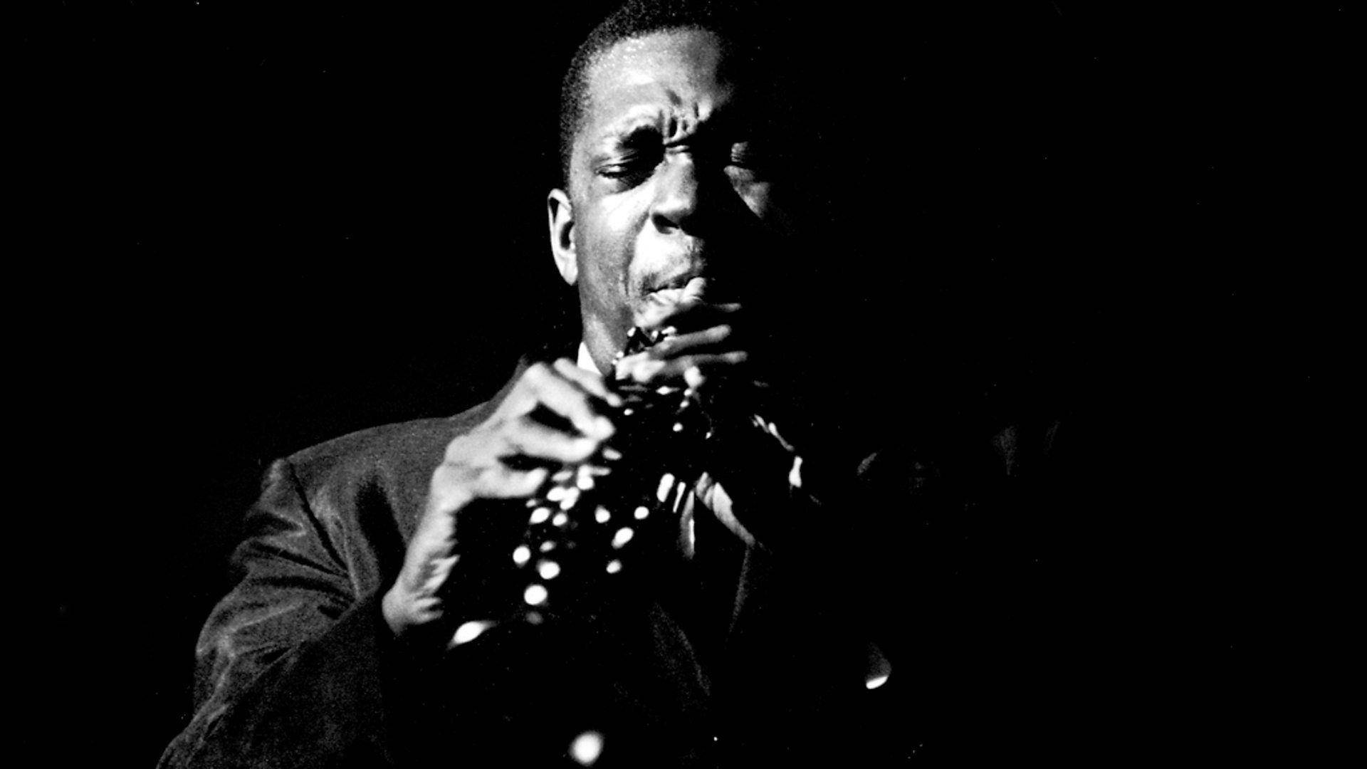 Legendary American Saxophonist John Coltrane Playing At The Village Gate In 1961 Background