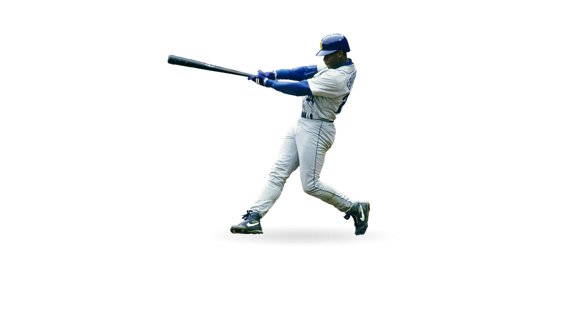 Legendary Baseball Player Ken Griffey Jr Is Pictured Swinging A Bat. Background
