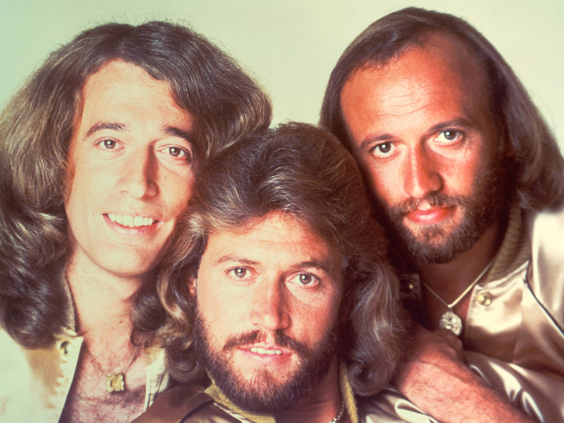 Legendary Bee Gees Group Portrait From 1977 Background