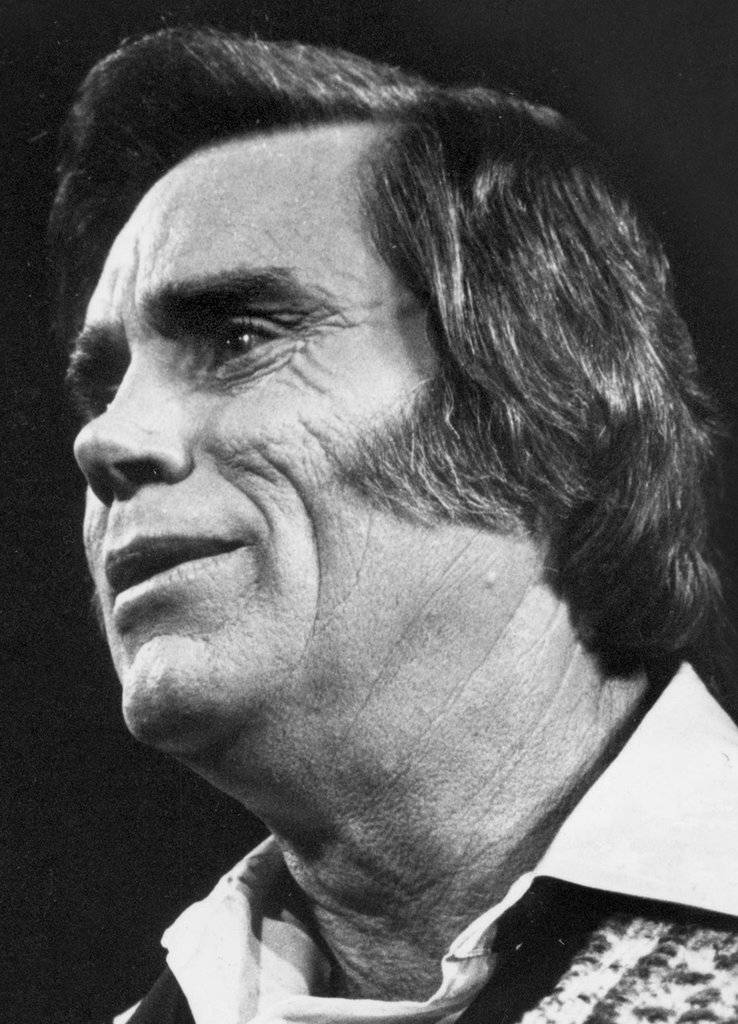 Legendary Country Singer George Jones In Black And White Background