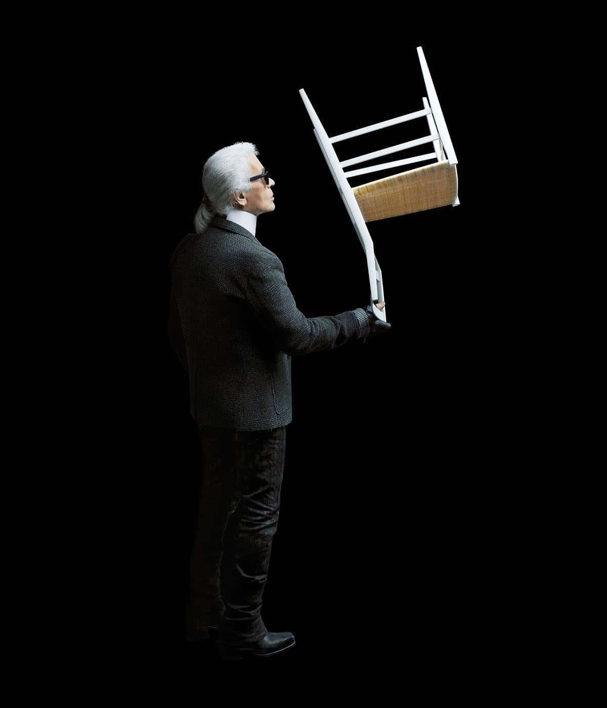 Legendary Fashion Designer Karl Lagerfeld Poses For A Photo Background