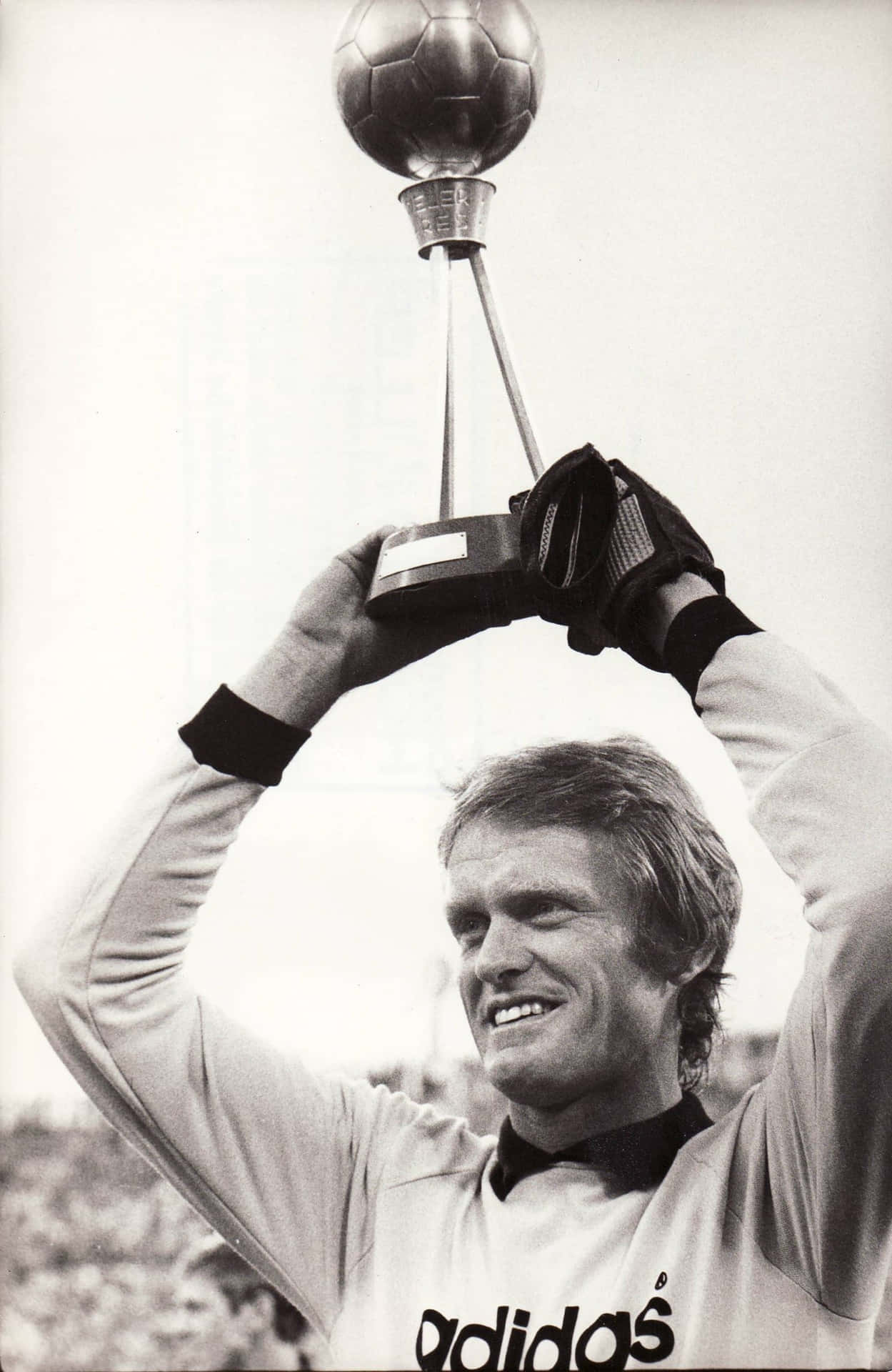Legendary German Goalkeeper Sepp Maier Holding A Football Trophy. Background