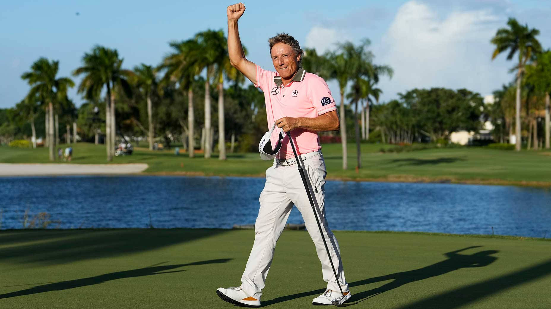 Legendary Golfer Bernhard Langer Celebrating With A Raised Hand Background