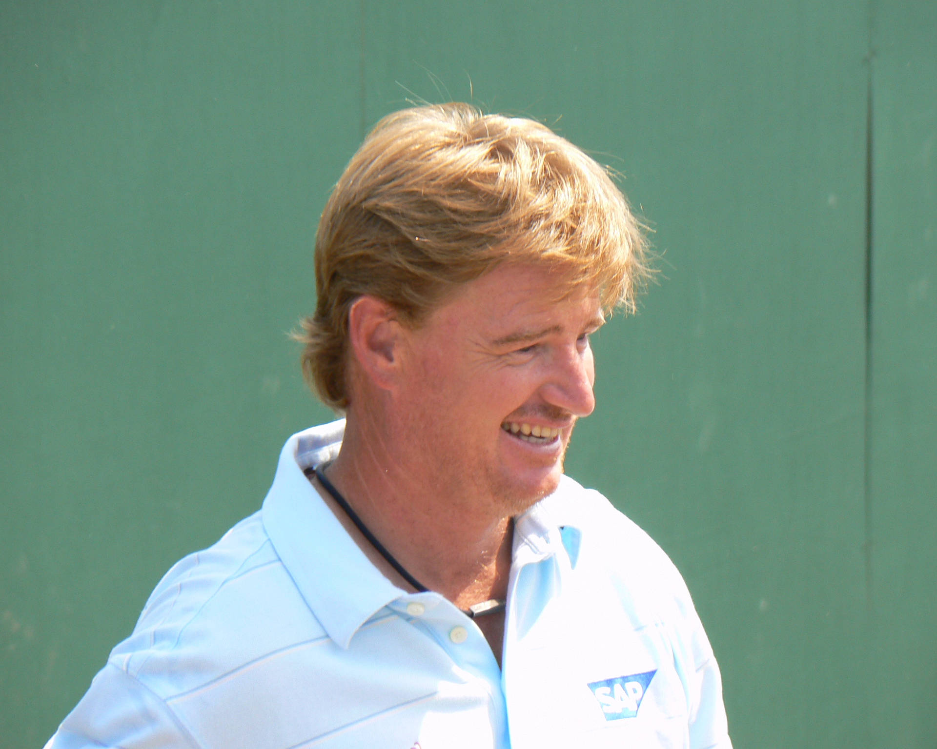 Legendary Golfer Ernie Els Smiling At An Event Background