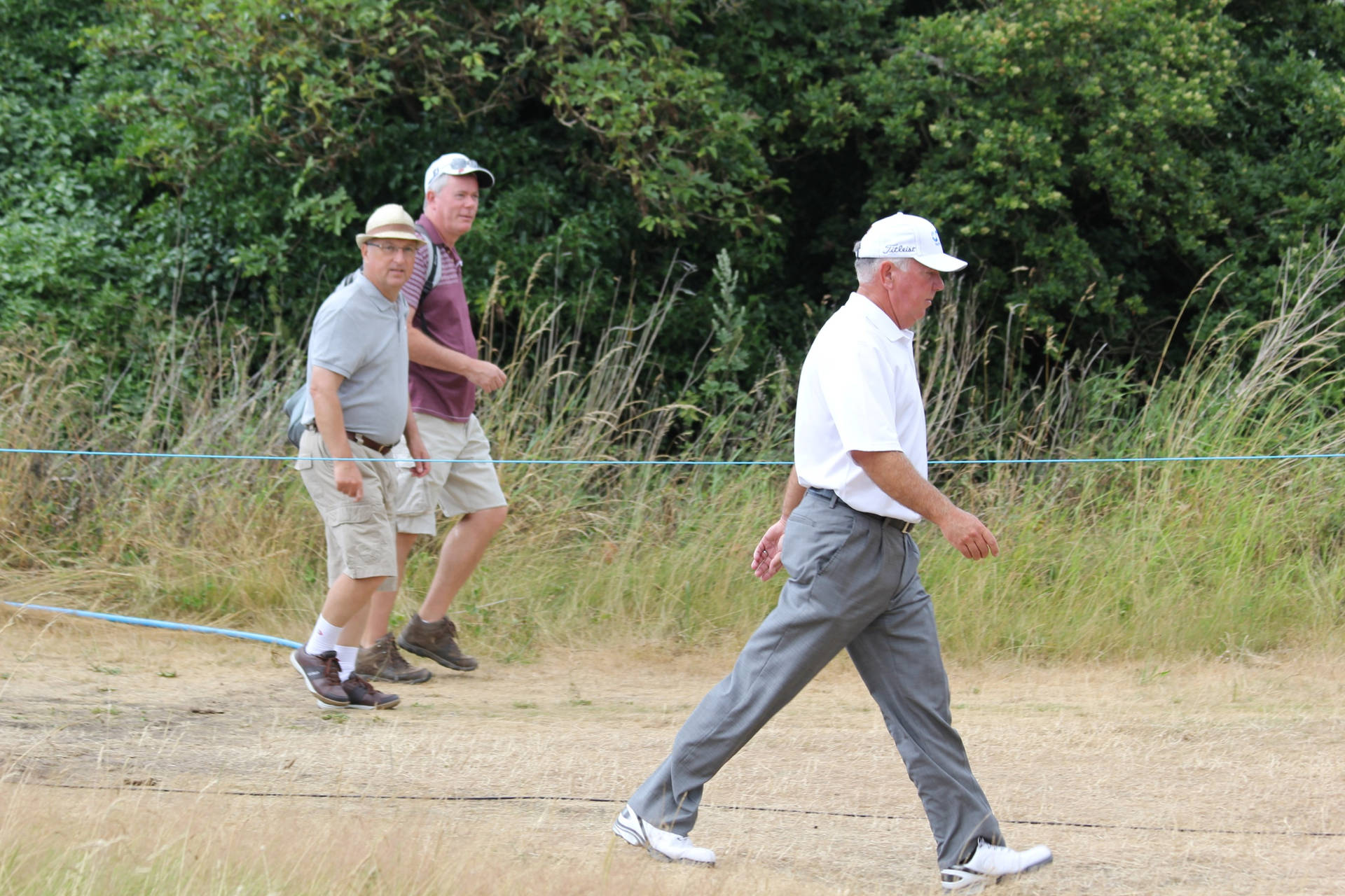 Legendary Golfer Mark O'meara Navigating A Grassy Path Background