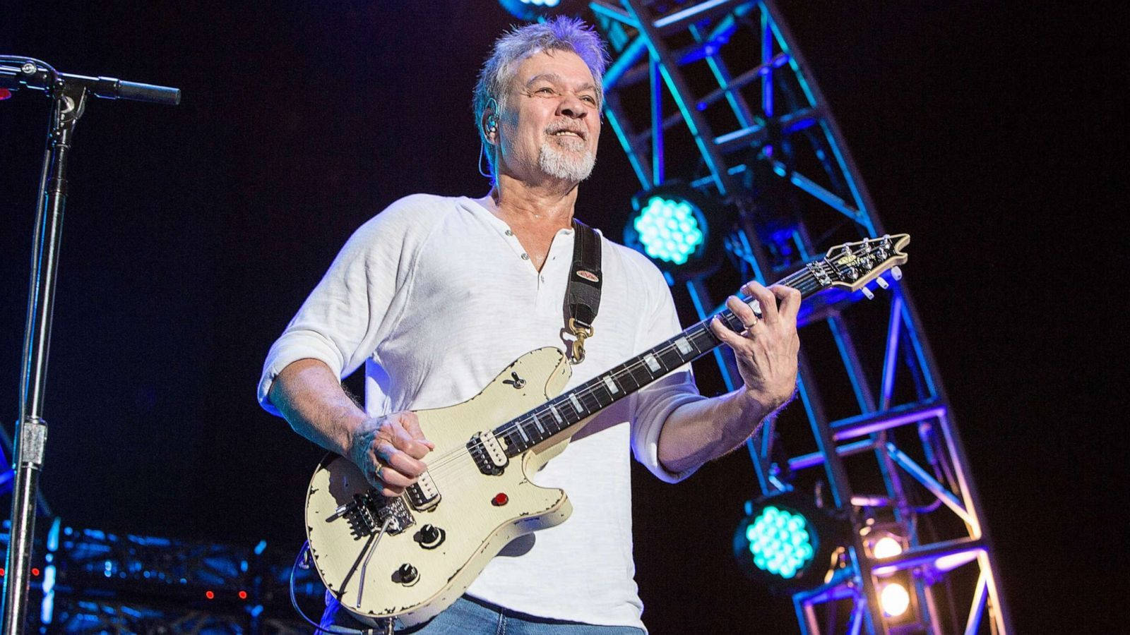 Legendary Guitarist Eddie Van Halen In Spotlight Background