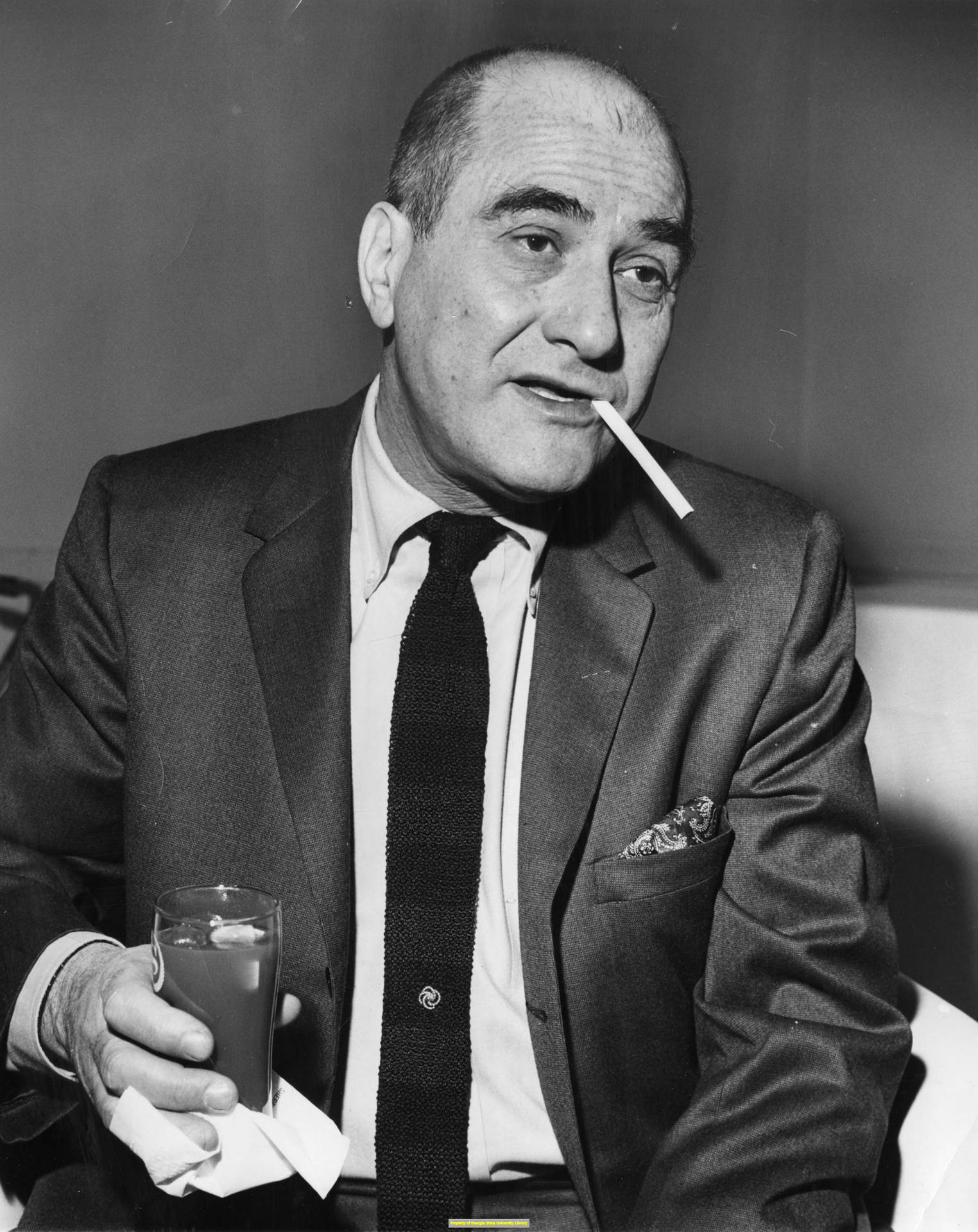 Legendary Jazz Musician Artie Shaw Pensively Smoking A Cigarette Background