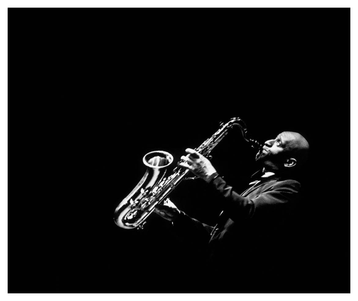 Legendary Jazz Saxophonist Sonny Rollins In Performance Background