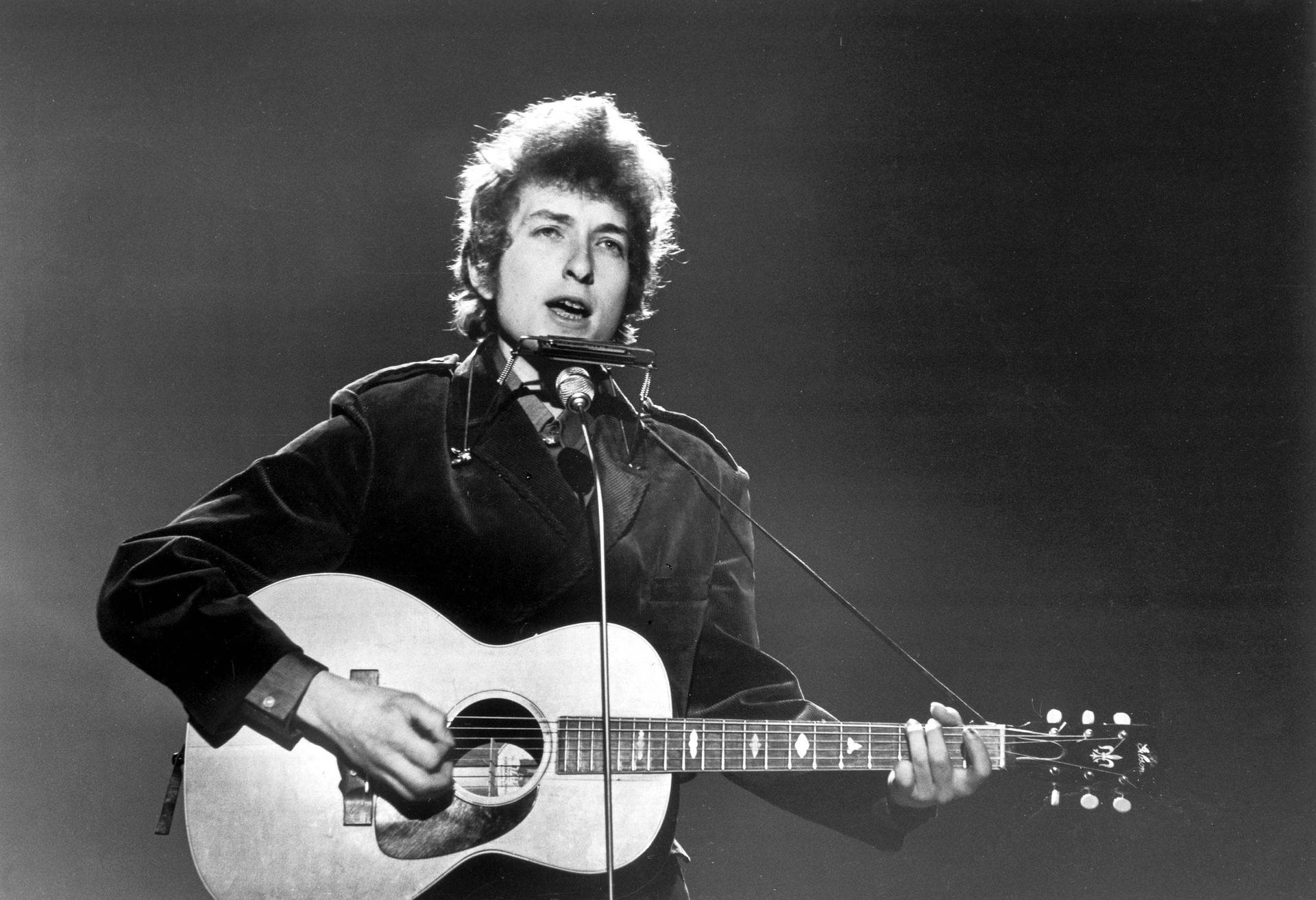 Legendary Music Icon Bob Dylan Strumming His Guitar Background