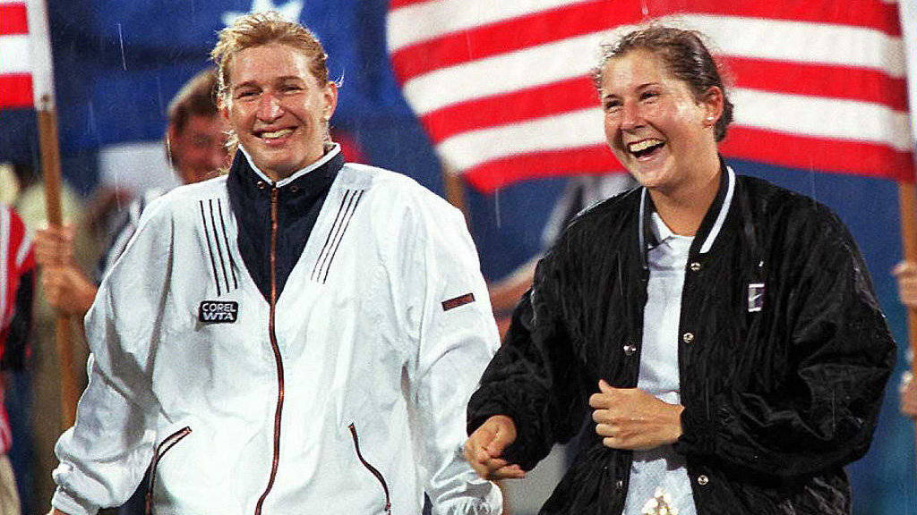 Legendary Tennis Icons Monica Seles And Steffi Graf Sharing A Laugh Background