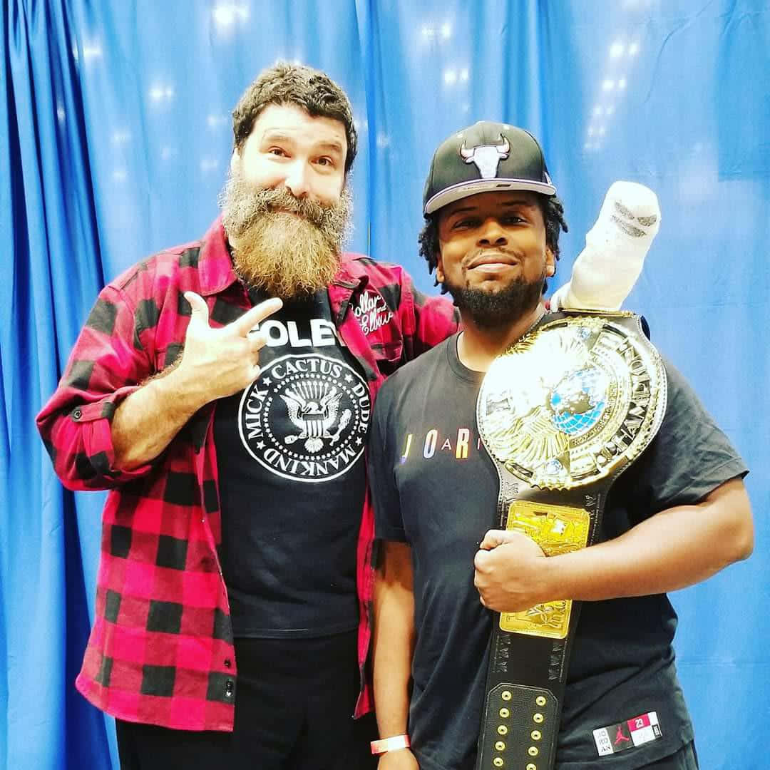 Legendary Wwe Wrestler Mick Foley At Summerslam Event Background
