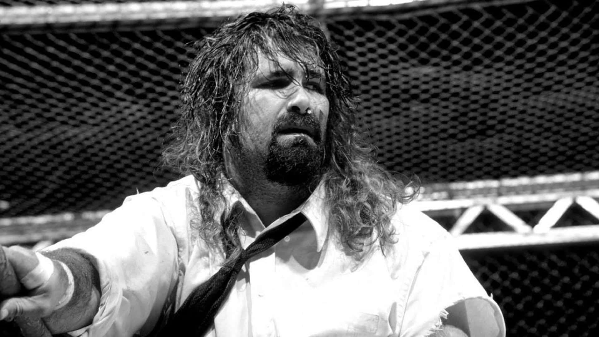 Legendary Wwe Wrestler Mick Foley In The Middle Of A Sensational Match In 1998. Background
