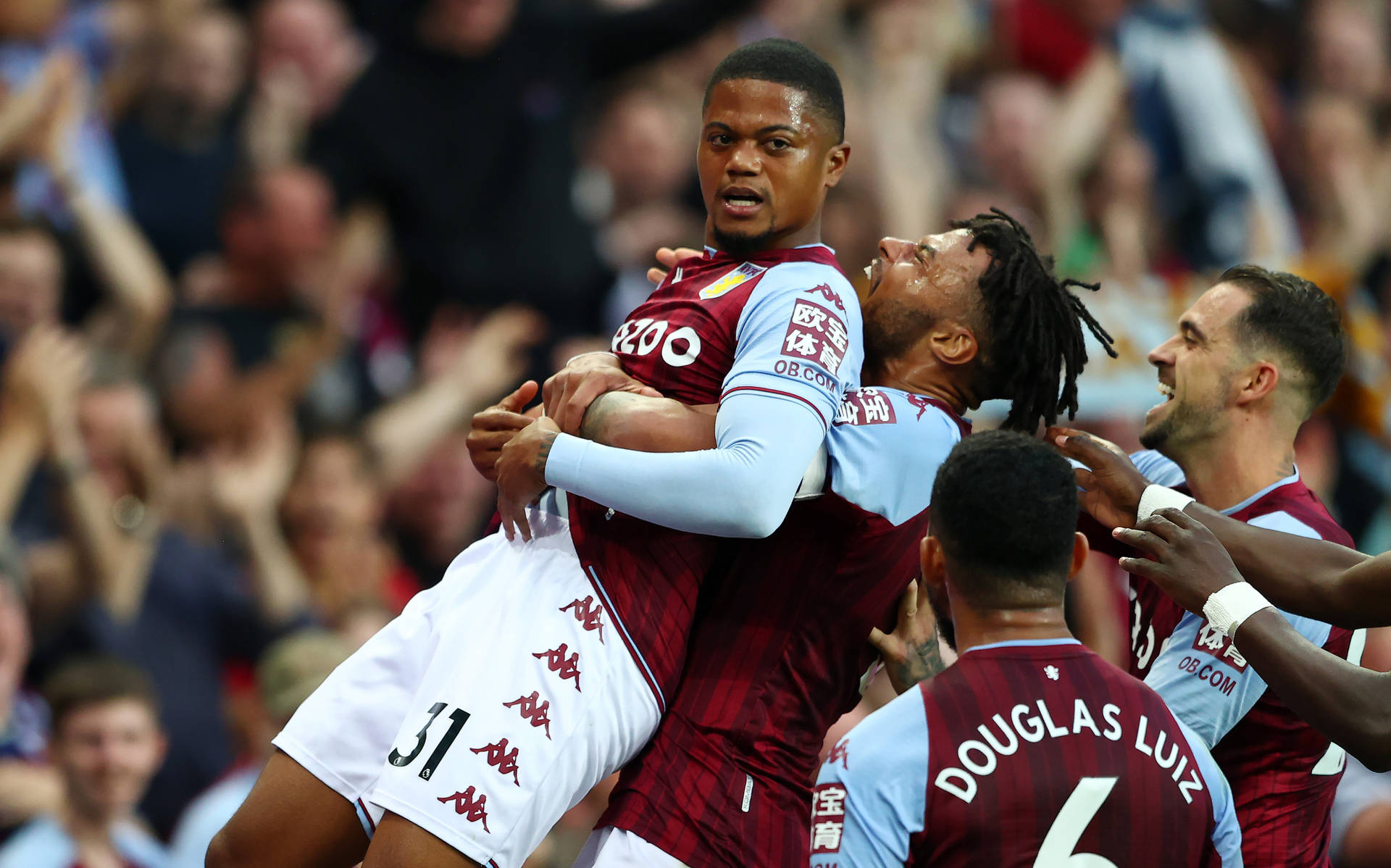 Leon Bailey Being Hugged Background