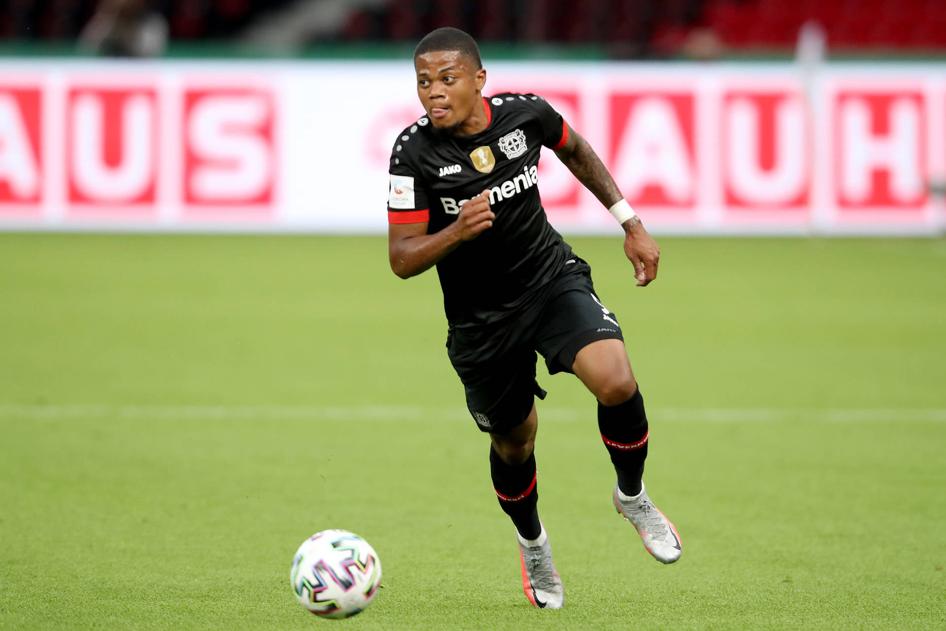 Leon Bailey Running With Ball Background